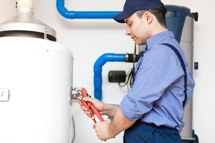 plumber performing water heater maintenance in broad run va